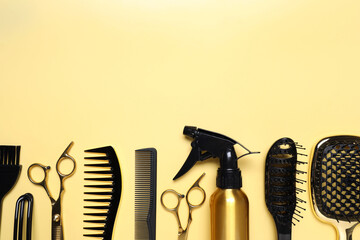 Hairdressing tools on yellow background, flat lay. Space for text