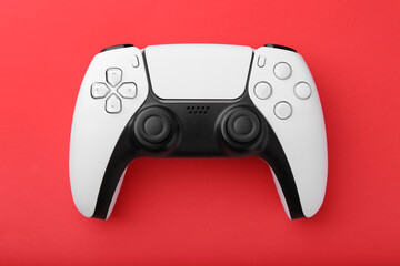 Wireless game controller on red background, top view