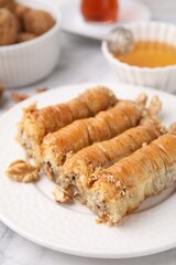Eastern sweets. Pieces of tasty baklava on white marble table, closeup