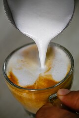 Isolated high resolution large of a single steaming hot coffee cup preparation- cappuccino in a restaurant- Israel