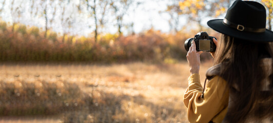 Nature photographer with dslr camera in autumn forest, Professional photography works