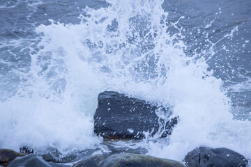 Ocean waves splashing on a rocky shore