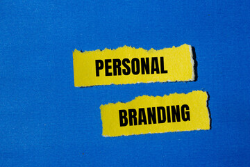 Personal branding words written on ripped yellow paper pieces with blue background. Conceptual...