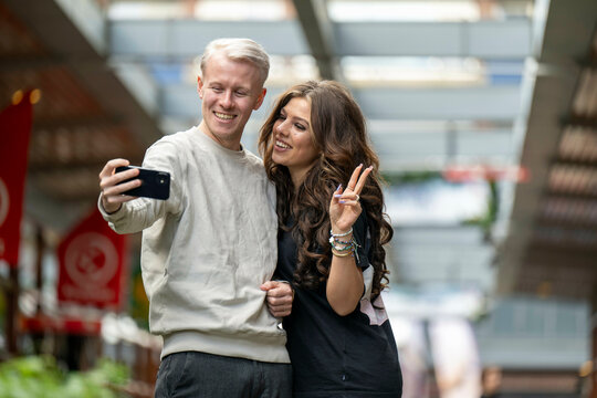Couple taking a selfie with peace sign gesture