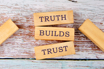Truth builds trust symbol. Concept words Truth builds trust on wooden blocks on old boards