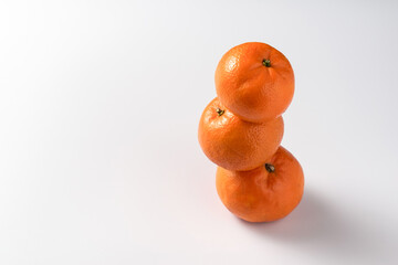 Tangerines or clementines are laid out on a white background. Ripe tangerines natural source of vitamin C laid out on a white background