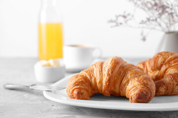 Tasty breakfast. Fresh croissants on grey table, closeup