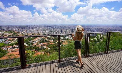 Holidays in Belo Horizonte, Brazil. Panoramic banner view of traveler girl enjoying cityscape of the metropolitan area of Belo Horizonte, Minas Gerais, Brazil