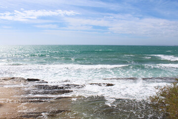 waves on the beach, natural blue background, beautiful coast of the Mediterranean Sea in Alicante,...