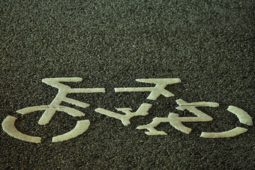 Close-up of white bicycle sign on the road. Bikeway symbol, bike lane sign.