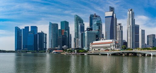 Panorama of Singapore skyline with Merlion statue fountain.