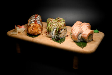 Restaurant japanese food sushi sets with herbs on a black background