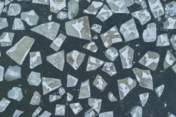 Photo background texture of ice floes floating in the Baltic Sea, photo from a drone looking down.