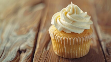 Delicious cupcake with white frosting on a rustic wooden table. Perfect for bakery or dessert themed designs
