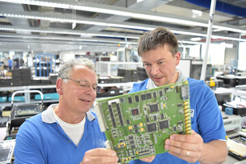 teamwork in a modern industrial factory - group of workers in the production and development of electronics - 791711785