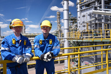 group of workers professional equipment in a petroleum refinery - modern buildings and industrial...