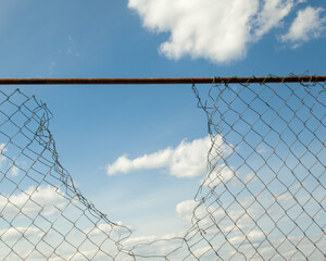 Broken metal mesh fence