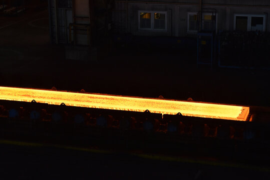 glowing brame in a steel mill - industrial factory for the production of metal sheets