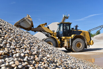 heavy construction machine in open-cast mining - wheel loader transports gravel in a gravel plant - 791717926