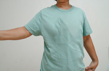 A woman wearing a blue t-shirt with her arms at her sides.