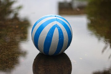 blue plastic ball on a puddle