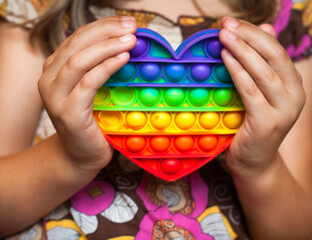 Girl holding heart shaped pop it toy