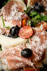 Mix of meat slices, tomato, green leaves, black olives with a parmesan - 791734354