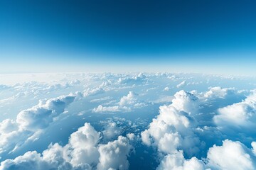 A clear blue sky with fluffy white clouds as seen from an aerial view from a plane