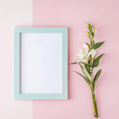 White, blank sheet in a blue frame on a pink background with flowers
