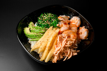 Black plate with mixed of shrimp, avocado, rice, greens and seaweed and sauce - 791737353