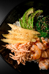 Top view of plate with rice,shrimp and seaweed stands on a black background - 791737969