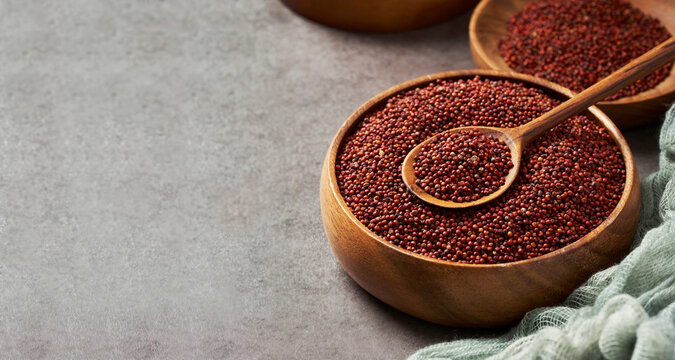 red finger millet or ragi raagi nachni in wood bowl and spoon on food table background copy space