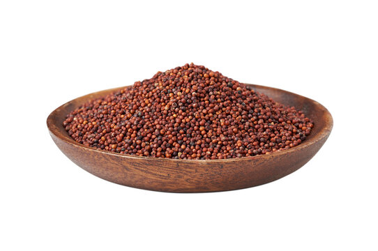 pile of red finger millet or ragi raagi nachni isolated on white background in wood bowl
