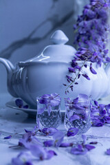 GLasses with water and purple flowers