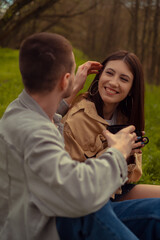 Obraz premium A man tenderly strokes the woman's hair, signifying romantic connection and friendship. First date in the woods, lakeside camping, and tea time in the park. Valentine's Day