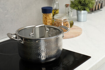 Cooking dinner. Pot on cooktop in kitchen