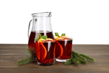 Aromatic Christmas Sangria drink and fir branches on wooden table against white background