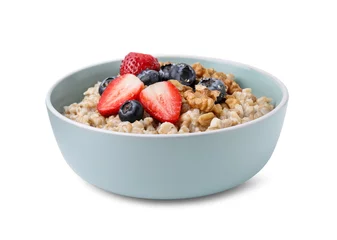 Foto op Plexiglas Tasty oatmeal with strawberries, blueberries and walnuts in bowl isolated on white © New Africa