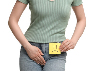 Woman holding sticky note with drawn sad face and suffering from cystitis on white background,...