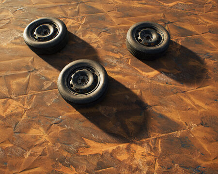 Three old car wheels on weathered rusty painted metal sheet.