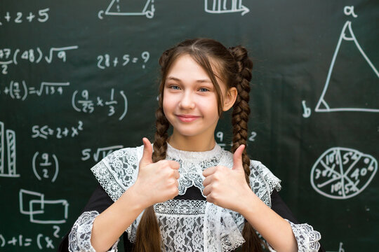 Happy teenage schoolgirl rejoices a good result in an exam, concept of success in school life.