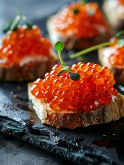 Decadent salmon roe canapes showcased on a dark slate surface, the bright orange pearls beautifully contrasted against the creamy white spread and artisanal breads.