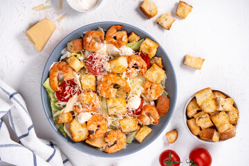 Shrimp Caesar Salad in a Bowl with Parmesan Cheese, Dressing and Croutons