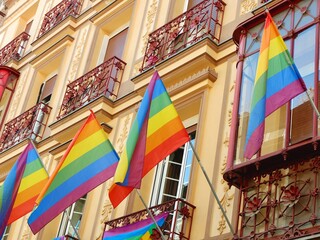 Vintage facades with vivid rainbow flags as a symbol of gay pride celebration in Chueca district, downtown Madrid, Spain