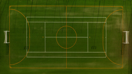 Aerial zenithal view of a multipurpose football field. There is no one and the sports center is empty.