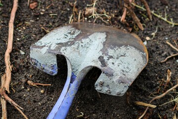 Handled shovel stuck in soil