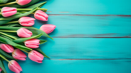 pink tulips on blue wooden surface.