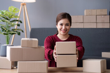 SME business entrepreneurs small in asia Preparing cardboard boxes in home office Small business...