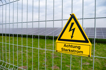 yellow warning sign Solar farms, capturing solar energy through photovoltaic panels, which contain...