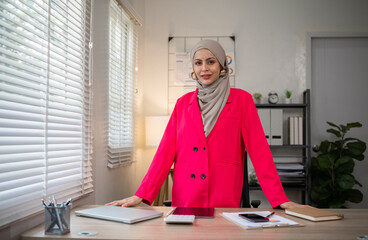 Confident Muslim businesswoman supervisor checks work on holiday and works in home office